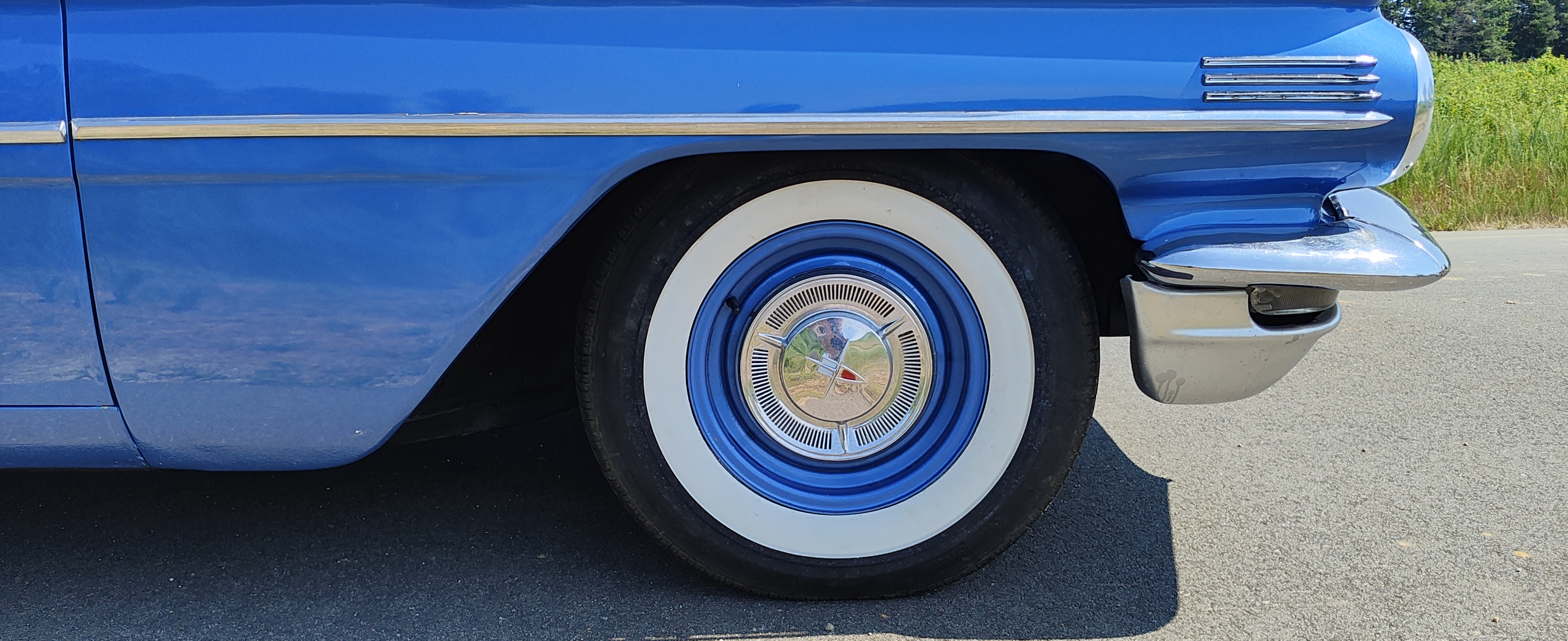 Whitewall tire and Oldsmobile wheel cover